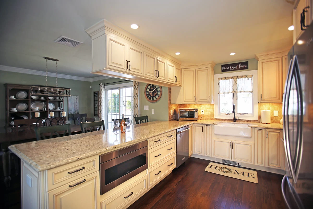 Kitchen remodel in Islip, New York with window in front of sink by Kuhn Construction