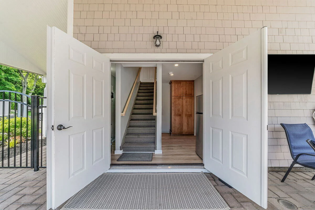 Doors opening to first floor of condo complex poolhouse remodel in Islip, NY by Kuhn Construction